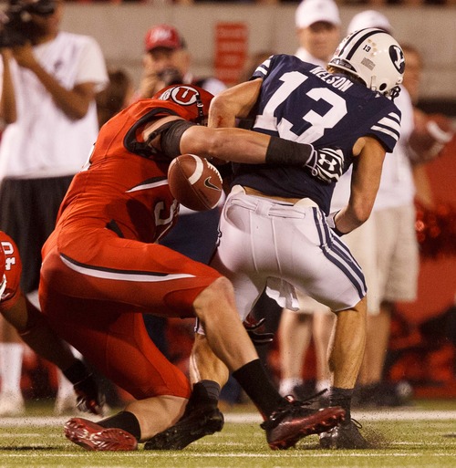 Trent Nelson  |  The Salt Lake Tribune
Utah defensive end Joe Kruger (99) sacks Brigham Young quarterback Riley Nelson, who fumbled the ball and then recovered it, during the game in Salt Lake City on Saturday, Sept. 15, 2012.