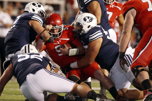 Chris Detrick  |  The Salt Lake Tribune
Utes quarterback Jon Hays is sacked by BYU defensive lineman Russell Tialavea (52),  linebacker Spencer Hadley (2) and defensive lineman Mike Muehlmann (95) during the second half of the game at Rice-Eccles Stadium on Saturday, Sept. 15, 2012.  Utah won the game 24-21.