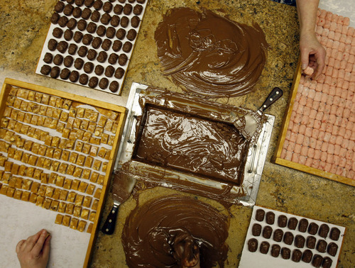Tribune file photo
Chocolates are still dipped by hand at the Bluebird Candy Company in Logan.