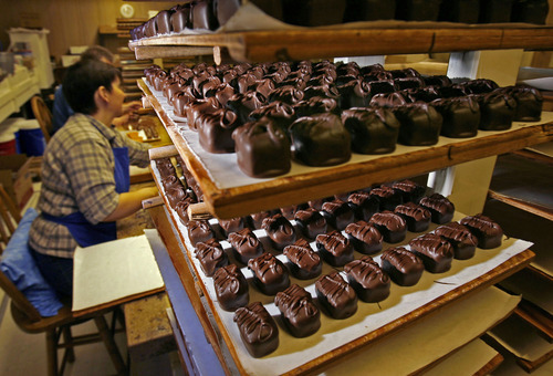 Tribune file photo
Chocolates are still dipped by hand at the Bluebird Candy Company in Logan.