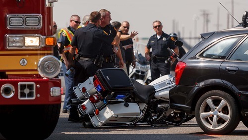 Trent Nelson  |  The Salt Lake Tribune
Emergency personnel at the scene of a crash involving Salt Lake City police motorcycle officers at 400 West, 400 South in Salt Lake City, Utah, Tuesday, September 18, 2012.