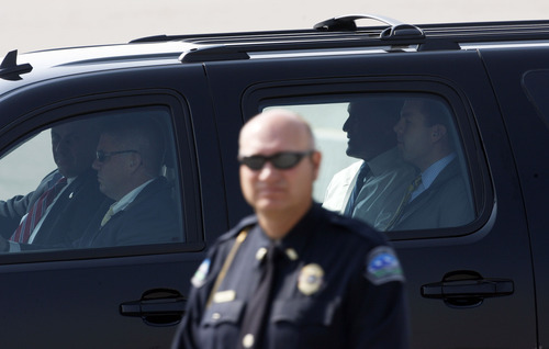 Francisco Kjolseth  |  The Salt Lake Tribune
Republican presidential candidate Mitt Romney, is escorted out of the airport in the back of an SUV after arriving in Utah for a pair of fundraisers on Tuesday, September 18, 2012, in what is expected to be his last stop in the state before the November election.
