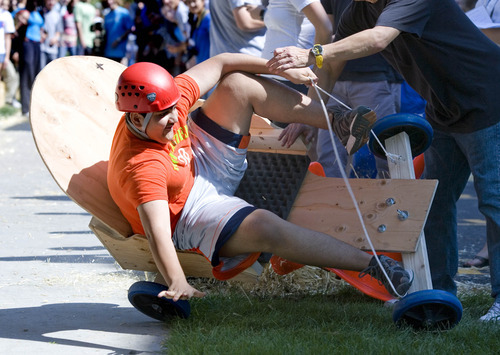 Paul Fraughton | The Salt Lake Tribune
Shabir Aminzada, a Rowland Hall sophomore, carries too much speed into the corner and crashes at the bottom of a hay bale lined course on the sidewalk south of the school. The cars, built by the students earlier in the day, were part of a science lesson dealing with potential and kinetic energy. The event was part  of the school's 
