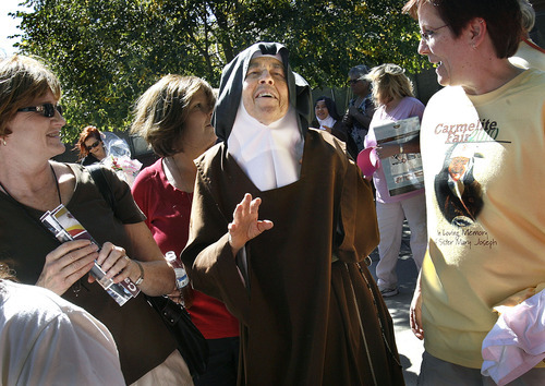 Scott Sommerdorf  l  The Salt Lake Tribune
Mother Maureen of the Trinity walks through the crowd and greets visitors to the Carmelite Fair at the Carmelite Monastery in Holladay, Sunday, Sept. 19, 2010.