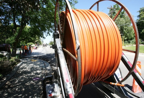 Steve Griffin  |  The Salt Lake Tribune

 A giant roll of orange conduit is at the ready as crews for Utopia, far left, use a drill to make a path for the conduit in Centerville,  Utah Monday, August 22, 2011. The conduit will house fiber optic cables.