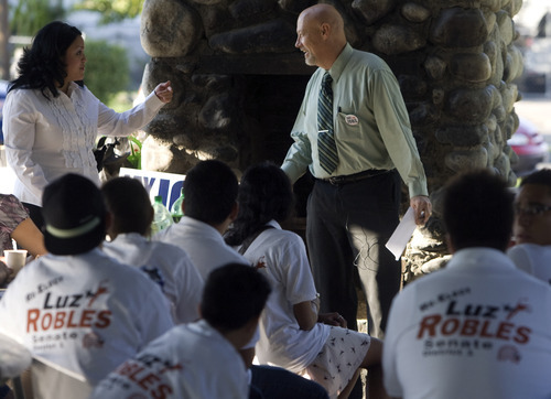Kim Raff | The Salt Lake Tribune
Congressional candidate Jay Seegmiller, right, and state Sen. Luz Robles, D-Salt Lake City, talk with volunteers during a kickoff Latino outreach Wednesday evening in Riverside Park in west Salt Lake City.