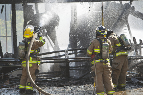 Chris Detrick  |  The Salt Lake Tribune
Unified Fire fighters work at putting out hot spots at house fire at 3785 West Dimrall Drive Thursday September 20, 2012.