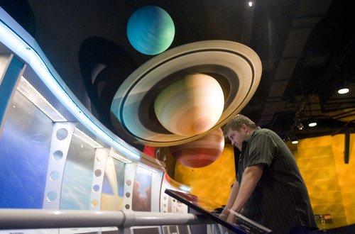 Kim Raff |  The Salt Lake Tribune
Nathan Roberts looks at the solar system exhibit at Clark Planetarium in Salt Lake City on Thursday, Sept. 20, 2012. Ticket prices will go up starting Oct. 1.
