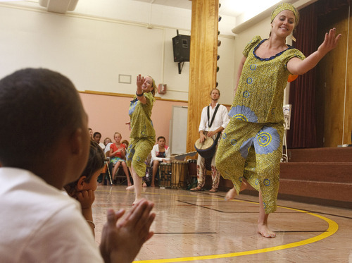 Leah Hogsten  |  The Salt Lake Tribune
Drummers and dancers Rosie Banchero (left) and Whitney Hobson (right) keep the African drum beat. Students and teachers at Cottonwood Elementary were treated to dancers and musicians showcasing the culture of Africa as part of the school's Friend to Friend service project for children in the Samburu District of the Rift Valley Province, Kenya, Friday, September 21, 2012. . The goal of the project is for Cottonwood students to make personal connections with the children in Africa.