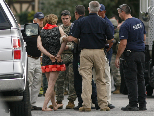 Scott Sommerdorf  |  The Salt Lake Tribune             
David Charles Baker in custody wearing a dress after police arrested him at his home after a long standoff. Unified Police respond to a report of a man barricaded in his home with possible explosives at 3128 Del Mar in Millcreek, Sunday, September 23, 2012.