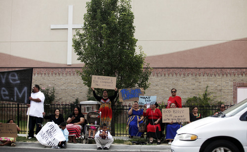 Ashley Detrick  |  The Salt Lake Tribune
Members of the Tongan United Methodist Church in West Valley City protest outside the church on Sunday September 23, 2012.  Members of the West Valley City church protested the temporary removal of their pastor, Rev. Havili Mone. The members are upset that they were not given an explanation for the move and that the replacement pastor locked members out of the church last week.