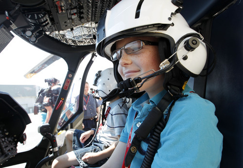Al Hartmann  |  The Salt Lake Tribune  
Hayden Held of Riverton wearing a pilot's helmet gets a view of the helicopter's controls during a VIP tour of one of the new Life Flight Agusta Grand helicopters that Intermountain Medical Center has purchased. They are able to fly at 200 miles per hour.