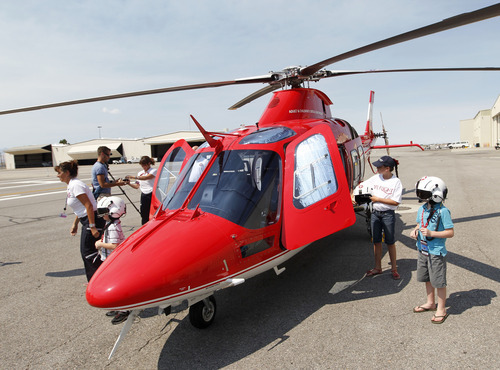 Al Hartmann  |  The Salt Lake Tribune  
Three winners of a contest take a VIP tour of one of the new Life Flight Agusta Grand helicopters that Intermountain Medical Center has purchased.