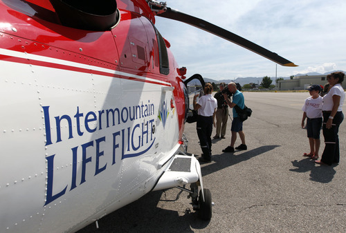 Al Hartmann  |  The Salt Lake Tribune  
Three winners of a contest take a recent VIP tour of one of the new Life Flight Agusta Grand helicopters that Intermountain Medical Center has purchased.  They are able to fly at 200 miles per hour.