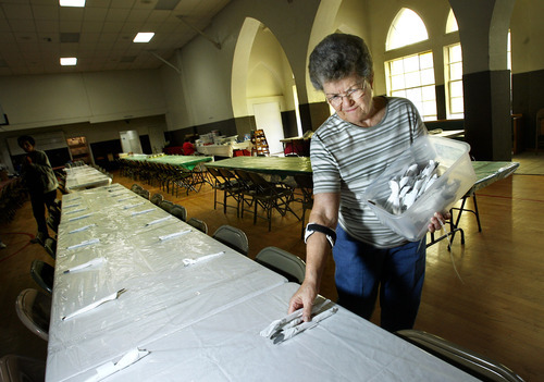 Scott Sommerdorf  |  Salt Lake Tribune
Jan Sullivan sets one of the many tables with silverware in the Our Lady of Lourdes Catholic Church in Magna. The church has hosted its annual spaghetti dinner fund-raiser for 78 years, just two years shy of the 80 years Magna's sole Catholic church has served area parishioners. This year's 78th annual church fund-raiser will raise funds for a new church roof, as well as community outreach programs.