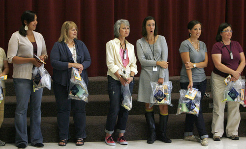 Francisco Kjolseth  |  The Salt Lake Tribune
Teachers watch as more of their colleagues are called to receive a gift at Salt Lake City's Riley Elementary School on Thursday, September 27, 2012, where they were presented gift cards from Sam's Club to help them finance classroom supplies. Riley Elementary is a low-income, high minority school that struggles with a student population where 90 percent have free and reduced lunch and more than half are non-native English speaking students. A school assembly was organized to celebrate the donation. As every Sam's club across the country picked a school in their area to present a similar donation.