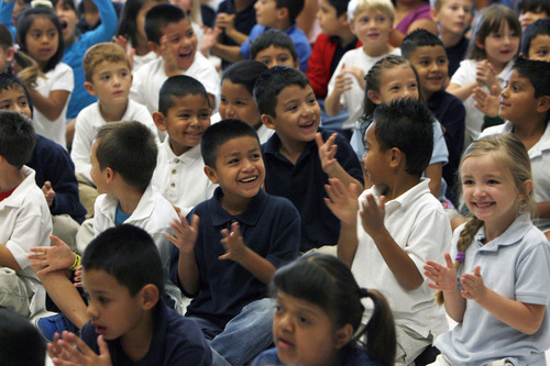 Francisco Kjolseth  |  The Salt Lake Tribune
Kids cheer on their teachers as 20 of them at Salt Lake City's Riley Elementary School got a boost on Thursday, September 27, 2012, when they are presented gift cards from Sam's Club to help them finance classroom supplies. Riley Elementary is a low-income, high minority school that struggles with a student population where 90 percent have free and reduced lunch and more than half are non-native English speaking students. A school assembly was organized to celebrate the donation. As every Sam's club across the country picked a school in their area to present a similar donation.