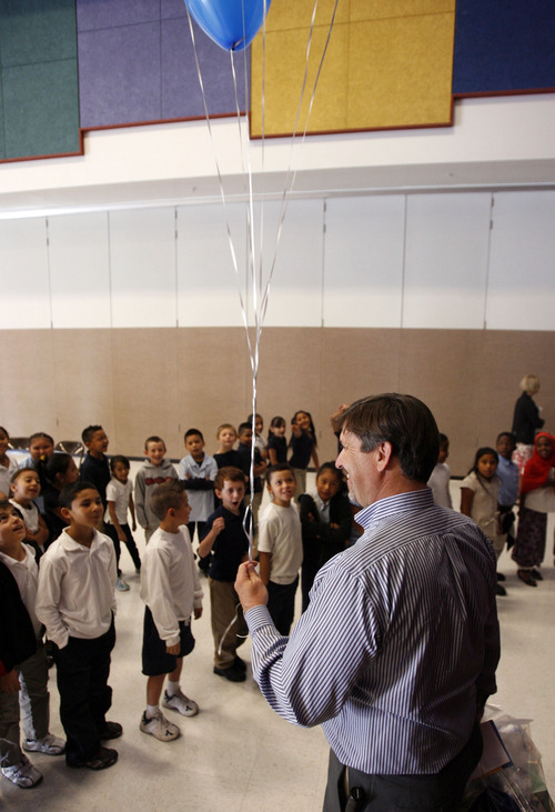 Francisco Kjolseth  |  The Salt Lake Tribune
Riley Elementary principal Randy Miller gets numerous requests for his balloons from students following a special presentation on Thursday, September 27, 2012. Twenty teachers at Salt Lake City's Riley Elementary School got a boost when they are presented gift cards from Sam's Club to help them finance classroom supplies. Riley Elementary is a low-income, high minority school that struggles with a student population where 90 percent have free and reduced lunch and more than half are non-native English speaking students. A school assembly was organized to celebrate the donation. As every Sam's club across the country picked a school in their area to present a similar donation.