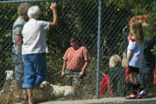 Chris Detrick  |  The Salt Lake Tribune
Family and friends of Reed Jeppson watch as members of the Salt Lake City Police Department search with cadaver dogs near 1400 South and 1900 East in Salt Lake City Saturday September 29, 2012. Reed Jeppson was 15 when he was last seen on Oct. 11, 1964.