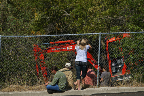 Chris Detrick  |  The Salt Lake Tribune
Family and friends of Reed Jeppson watch as members of the Salt Lake City Police Department use backhoe to search gully near 1400 South and 1900 East in Salt Lake City Saturday September 29, 2012. Reed Jeppson was 15 when he was last seen on Oct. 11, 1964.