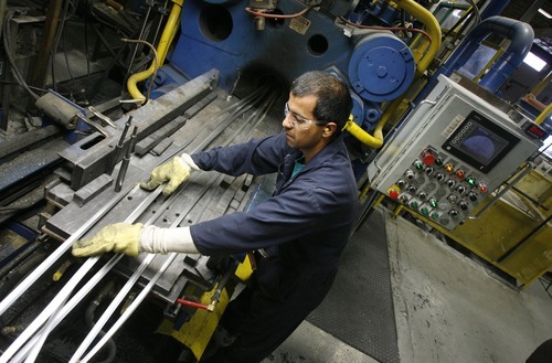 Francisco Kjolseth  |  The Salt Lake Tribune
Futura Industries' employee Jaime Coronado works with a large extrusion machine that heats and then exerts nearly 2,000 pounds of pressure to bend aluminum into numerous shapes for abundant products. Along with 19 other companies, the Clearfield firm will receive a Work/Life award Tuesday from the Utah Department of Workforce Services.