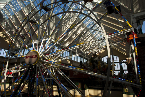 Chris Detrick  |  The Salt Lake Tribune
The Ferris wheel at Scheels Saturday September 29, 2012. Scheels opened its 220,000-square-foot mega-sporting goods store in Sandy. Featuring a 16-car Ferris wheel rising toward a skylight, a 16,000-gallon double-arched salt water aquarium, a boating department, game centers and a focus on fashionable apparel, the store is meant to be a fun destination, said Dan Hermanson, an assistant store leader.