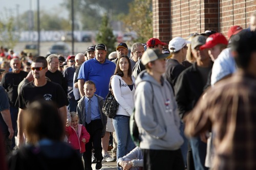 Chris Detrick  |  The Salt Lake Tribune
Customers wait in line to get into Scheels Saturday September 29, 2012. Scheels opened its 220,000-square-foot mega-sporting goods store in Sandy. Featuring a 16-car Ferris wheel rising toward a skylight, a 16,000-gallon double-arched salt water aquarium, a boating department, game centers and a focus on fashionable apparel, the store is meant to be a fun destination, said Dan Hermanson, an assistant store leader.