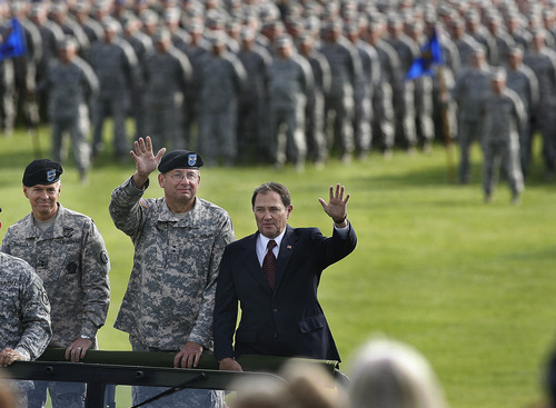 Scott Sommerdorf  |  The Salt Lake Tribune             
Utah Gov. Gary Herbert, commander in chief of the Utah National Guard, reviewed his troops Saturday in a pass-and-review ceremony from a Humvee with new adjutant general, Maj. Gen. Jefferson S. Burton, left, and Maj. Gen. Brian L. Tarbet, center. For the past five years, Burton has served as assistant adjutant general-Army in the Utah Guard, responsible for the training and support of 5,600 soldiers. As the new leader, he assumes command of 7,000 airmen and soldiers.