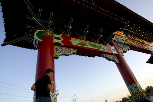 Kim Raff  |  The Salt Lake Tribune
Patrick Combs climbs on the Chinese Heritage Gate after its unveiling at the Utah Cultural Center in West Valley City, Utah on September 29, 2012. The gate, which is a symbol of friendship between West Valley City and Nantou, Taiwan, has come under scrutiny with some members of the Asian community who are upset about how the money has been handled.