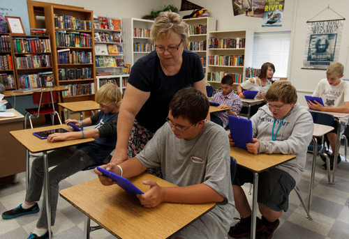 Trent Nelson  |  The Salt Lake Tribune
Dixon Middle School teacher Leann Moody helps Jacen Hansen with an iPad during a reading class in Provo, Utah, Tuesday September 25, 2012.