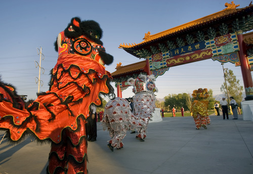 Kim Raff | The Salt Lake Tribune
Lion dancers from Sil Lum Kung Foo Kwoon dance around the Chinese Heritage Gate during the unveiling at the Utah Cultural Center in West Valley City on Sept. 29, 2012. The gate, which is symbol of friendship between West Valley City and Nantou, Taiwan has come under scrutiny with some members of the Asian community who are upset about how the money has been handled.