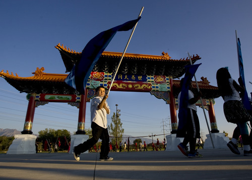 Kim Raff | The Salt Lake Tribune
Children from five different area schools who are part of the Chinese emersion program march around the Chinese Heritage Gate during an unveiling at the Utah Cultural Center in West Valley City on Sept. 29, 2012. The gate, which is symbol of friendship between West Valley City and Nantou, Taiwan has come under scrutiny with some members of the Asian community who are upset about how the money has been handled.