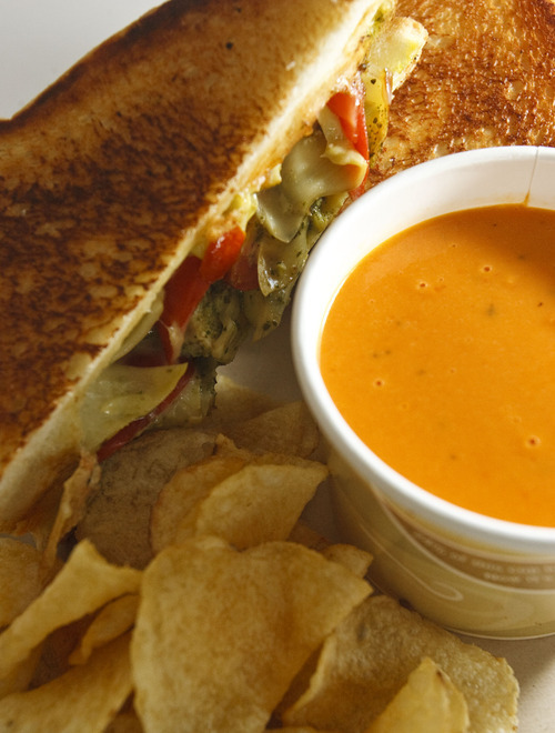 Leah Hogsten  |  The Salt Lake Tribune
The artichoke and tomato grilled cheese with a cup of tomato basil soup at the Melty Way, a fast-casual restaurant in Midvale that is putting a grown-up spin on grilled cheese sandwiches.