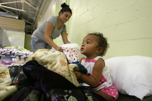 Steve Griffin | The Salt Lake Tribune


Rachel Jeffers and her one-year-old daughter, Keiana, prepare their sleeping area at the Midvale shelter in Midvale, Utah Monday October 1, 2012.  The winter overflow shelter is opening early this year due to the influx of homeless families the downtown Road Home shelter received this summer.