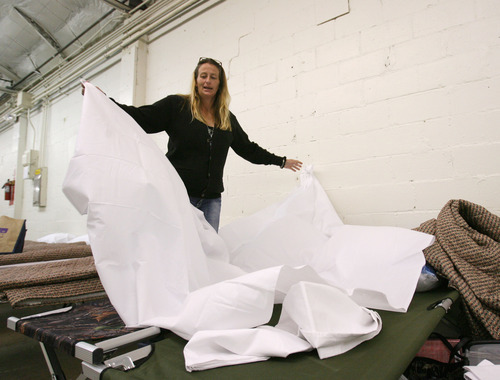 Steve Griffin | The Salt Lake Tribune


Michelle Webster unfolds sheets as she makes up her cots she and her five-year-old son will be sleeping on at the Midvale shelter in Midvale, Utah Monday October 1, 2012.  The winter overflow shelter is opening early this year due to the influx of homeless families the downtown Road Home shelter received this summer.