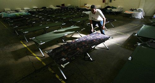 Steve Griffin | The Salt Lake Tribune


Alan Moore, a cold weather temporary employee at the Midvale shelter in Midvale, Utah sets up cots Monday October 1, 2012.  The winter overflow shelter is opening early this year due to the influx of homeless families the downtown Road Home shelter received this summer.