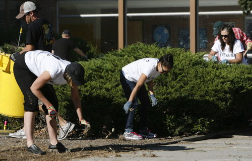 Francisco Kjolseth  |  The Salt Lake Tribune
Volunteers from Holland & Hart and 3M Health Information Systems help clean up the grounds at Kearns Junior High on Thursday, September 13, 2012. Numerous volunteers pulled weeds in the courtyard, moved new tables to the science lab and  helped tutor students in math and reading as part of the state-wide United Day of Caring.