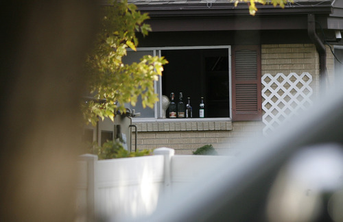 Scott Sommerdorf  |  The Salt Lake Tribune             
The window that suspect David Charles Baker has stacked bottles after he had knocked out the screen. Presumably to alert him if officers stormed through the window. Unified Police respond to a report of a man barricaded in his home with possible explosives at 3128 Del Mar in Millcreek, Sunday, September 23, 2012.