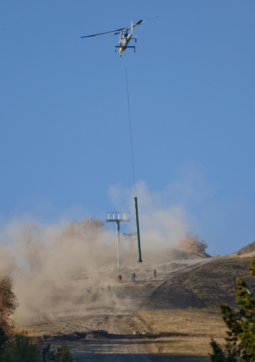 Michael Mangum  |  Special to the Tribune

A Kaman K-1200 helicopter kicks up dust as it lowers a ski lift tower into place for crews to secure it at Sundance Resort on Friday, October 5, 2012. The new, yet-to-be-named lift is expected to be operational on Dec. 7.
