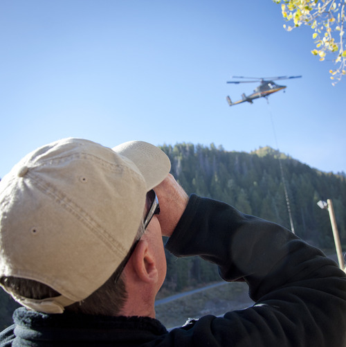 Michael Mangum  |  Special to The Salt Lake Tribune

Mike Griggs, a former helicopter pilot in the Marines who lives in Alpine, watches as a Kaman K-1200 hoists a tower for a new ski lift at Sundance Resort on Friday, October 5, 2012. The yet-to-be-named lift is expected to be operational by Dec. 7.