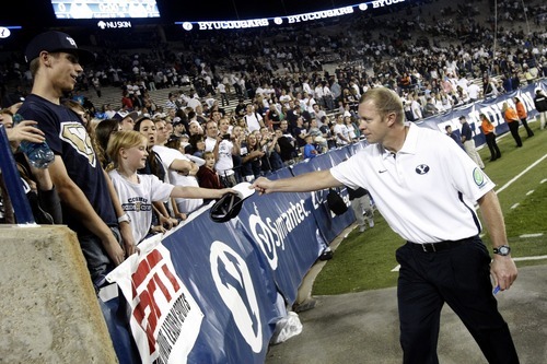Chris Detrick  |  The Salt Lake Tribune
Brigham Young Cougars head coach Bronco Mendenhall gives his his hat away to a fan after the game at LaVell Edwards Stadium Friday September 28, 2012. BYU won the game 47-0.