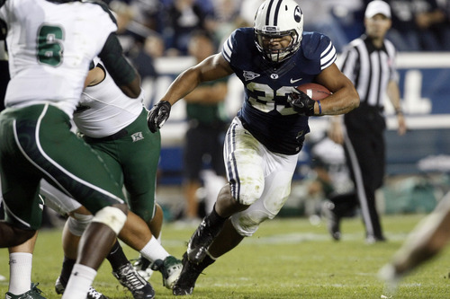 Chris Detrick  |  The Salt Lake Tribune
Brigham Young Cougars running back Paul Lasike (33) runs the ball past Hawaii Warriors linebacker Darryl McBride Jr. (6) during the second half of the game at LaVell Edwards Stadium Friday September 28, 2012. BYU won the game 47-0.