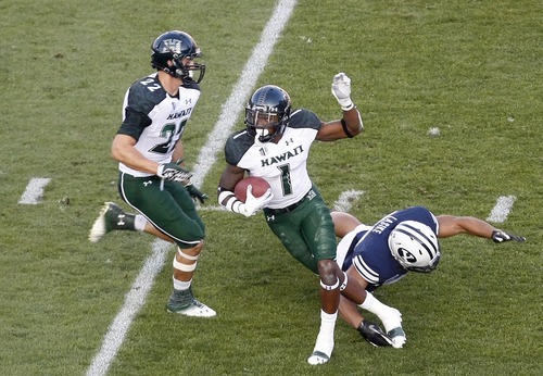 Chris Detrick  |  The Salt Lake Tribune
Hawaii Warriors cornerback Mike Edwards (1) is tackled by BYU defensive back Jacob Hannemann (33) during the first half of the game at LaVell Edwards Stadium on Friday, Sept. 28, 2012.