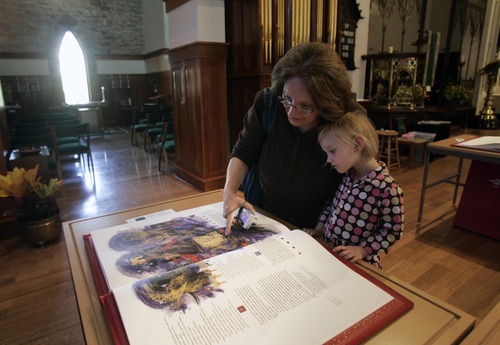 Kim Raff | The Salt Lake Tribune
Louona Tanner looks through Prophets with her granddaughter Sienna Pauli, one of the books in the reproduction of the St. John's Bible on display at the Cathedral Church of St. Mark in Salt Lake City on Oct. 3, 2012. The Bible was produced by St. John's Abbey and University, Collegeville, Minn. Renowned calligrapher Donald Jackson and a team of fellow artists and scribes were commissioned to produce this handwritten, hand-illuminated Bible whose seven volumes measure two feet high and three feet wide when opened.