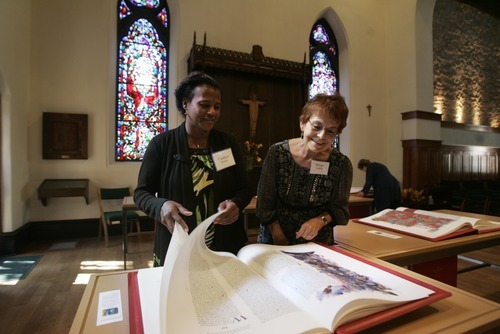 Kim Raff | The Salt Lake Tribune
(left) Clarence Bynum and Marge Tucker look through Pentateuch one of the book of the reproduction of the St. John's Bible on display at the Cathedral Church of St. Mark in Salt Lake City on Oct. 3, 2012. The Bible was produced by St. John's Abbey and University, Collegeville, Minn. Renowned calligrapher Donald Jackson and a team of fellow artists and scribes were commissioned to produce this handwritten, hand-illuminated Bible whose seven volumes measure two feet high and three feet wide when opened.