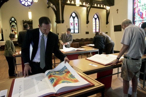 Kim Raff | The Salt Lake Tribune
Kyle Anderson looks through Prophets, one of the books in the reproduction of the St. John's Bible on display at the Cathedral Church of St. Mark in Salt Lake City on Oct. 3, 2012. The Bible was produced by St. John's Abbey and University, Collegeville, Minn. Renowned calligrapher Donald Jackson and a team of fellow artists and scribes were commissioned to produce this handwritten, hand-illuminated Bible whose seven volumes measure two feet high and three feet wide when opened.