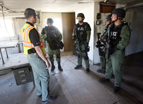 Steve Griffin | The Salt Lake Tribune
SWAT team members talk with Sgt. Jim Petre during training in an empty building in Clearfield. Clearfield, Clinton, and Syracuse have teamed up with Layton's SWAT team to form a bigger group.