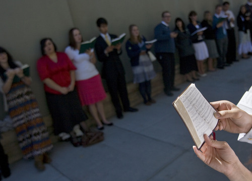 Kim Raff  |  The Salt Lake Tribune
People sing hymns to people walking to conference during the 182nd Semiannual General Conference of the LDS Church in Salt Lake City on Sunday, October 7, 2012.