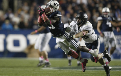 Chris Detrick  |  The Salt Lake Tribune
Brigham Young Cougars running back Jamaal Williams (21) can't make a catch under pressure from Utah State Aggies safety McKade Brady (36) during the second half of the game at LaVell Edwards Stadium Friday October 5, 2012. BYU won the game 6-3.