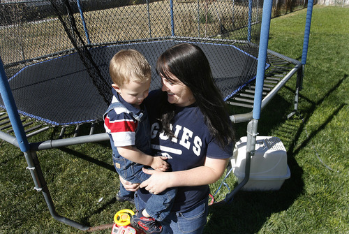 Scott Sommerdorf  |  The Salt Lake Tribune             
Loreena Cook and her son Damien in their backyard in Tremonton, Monday, October 1, 2012. Cook is among over 260 parents seeking to enroll their children in a state-sponsored autism treatment program.